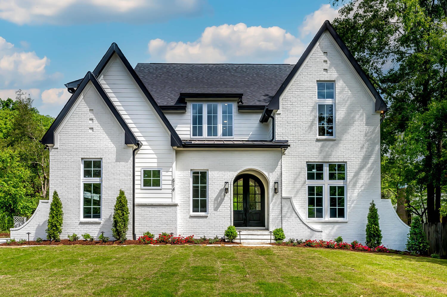 Front view of a modern white brick home in Raleigh, professionally photographed by real estate media specialist R. Huggins