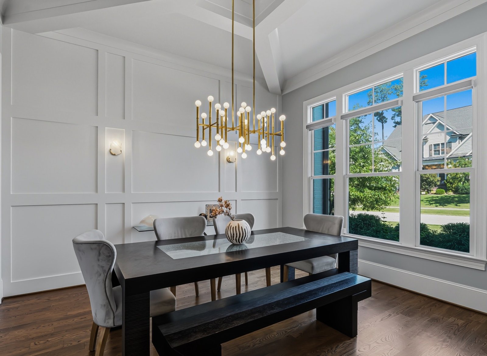 Bright dining room with gold chandelier and panelled walls, photographed by Raleigh real estate photographer R. Huggins