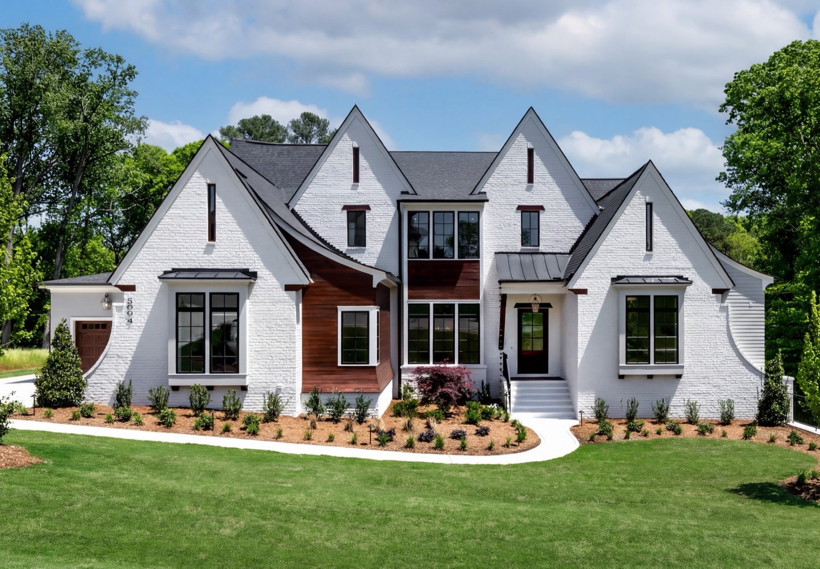 White modern farmhouse exterior with landscaped front yard, Raleigh real estate photography by R. Huggins