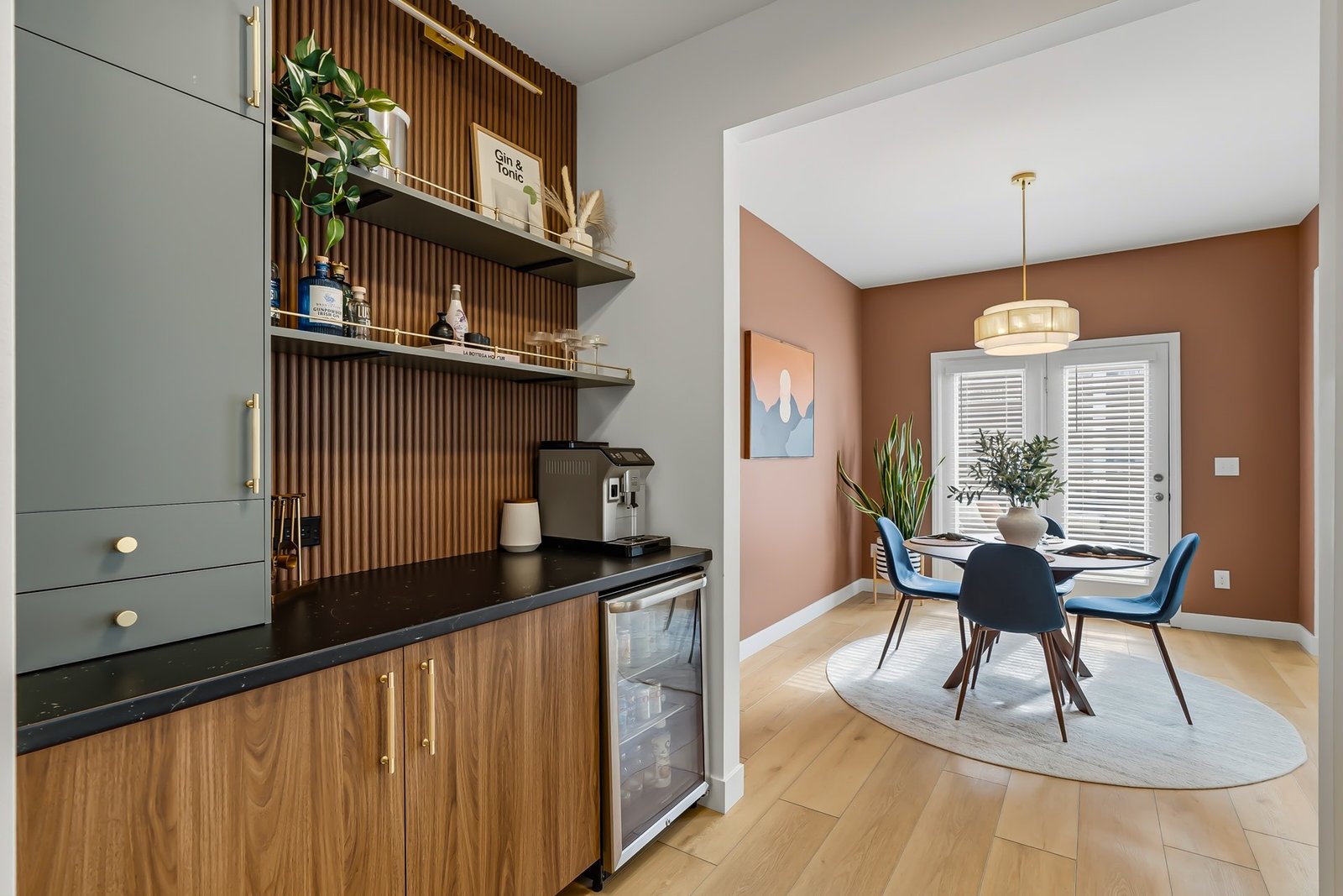 Modern coffee bar and dining nook with walnut cabinetry, real estate interior photography in Raleigh NC