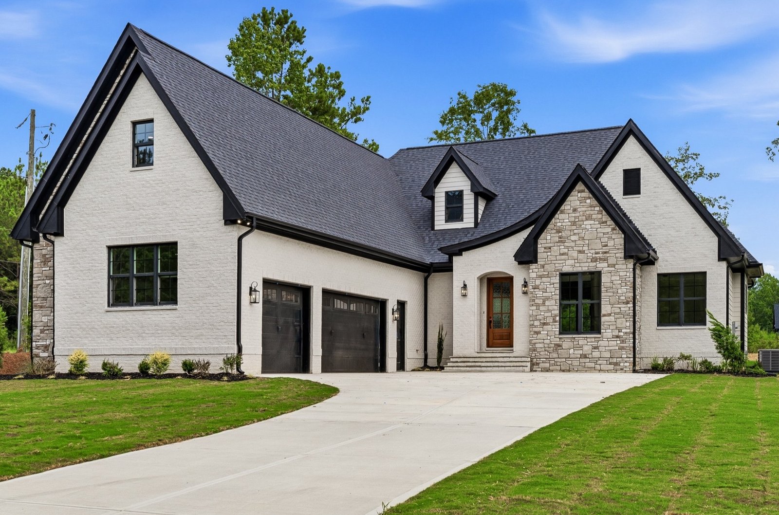 White brick and stone new-construction home exterior, professionally photographed in Raleigh by R. Huggins