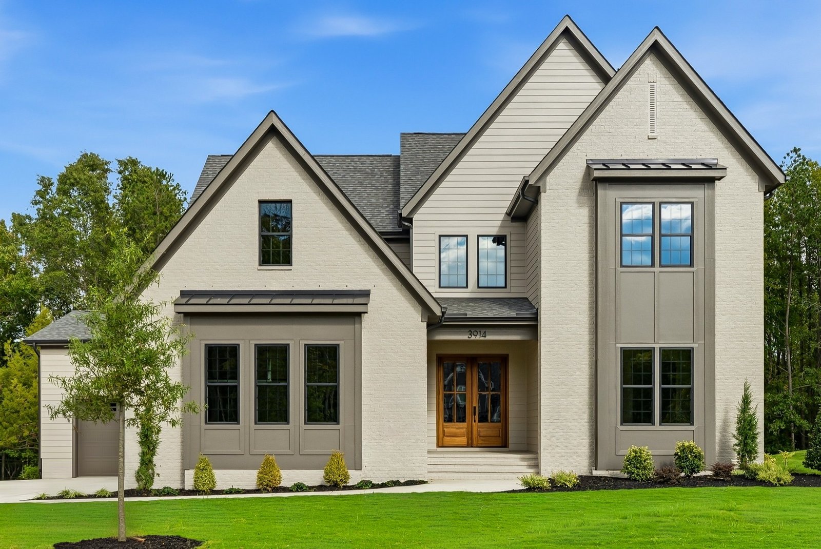 Contemporary two-story home exterior with wood front door, Raleigh real estate photography