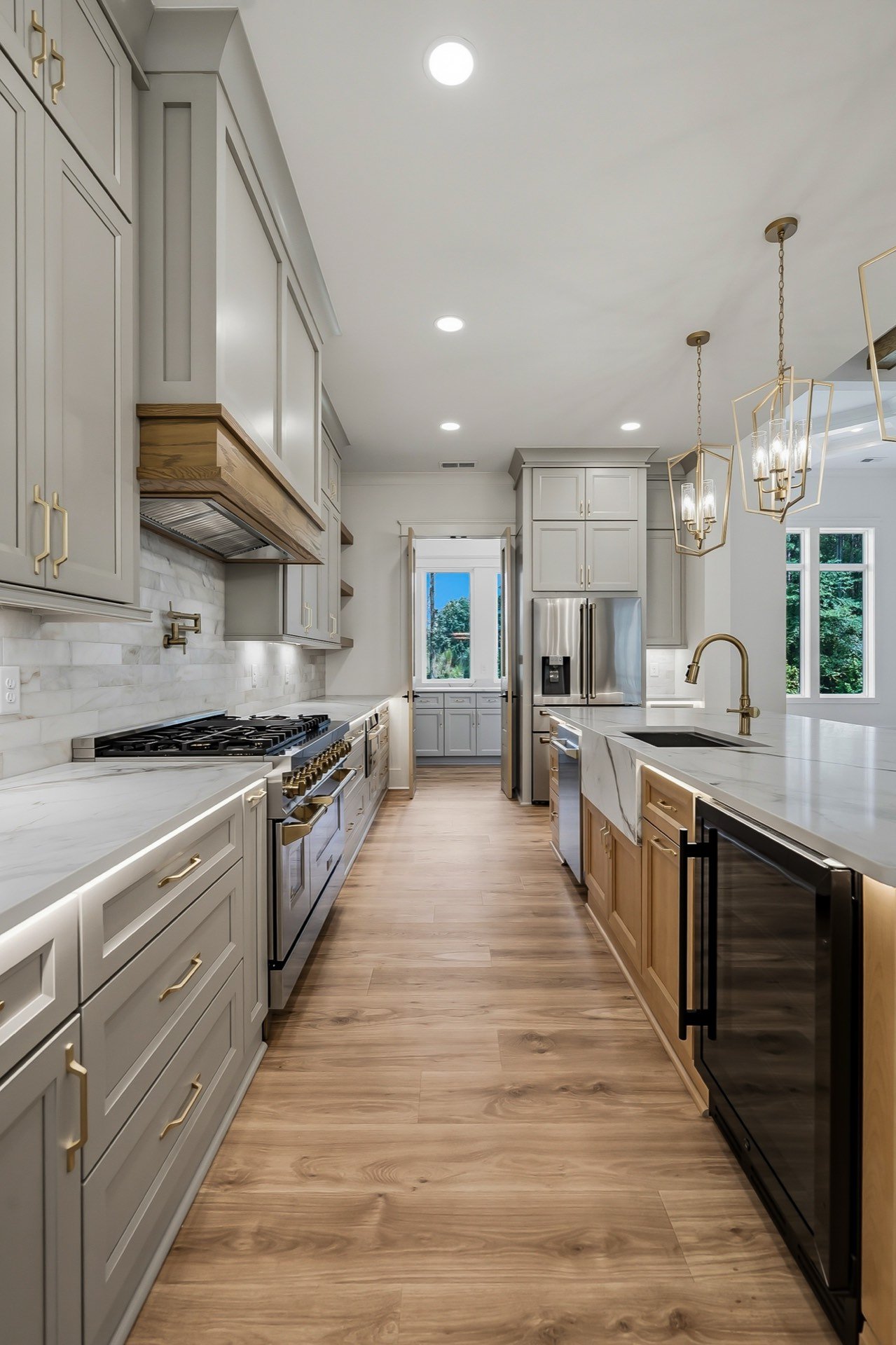 Galley kitchen with grey cabinets, quartz counters and pendant lights, Raleigh real estate photography by R. Huggins