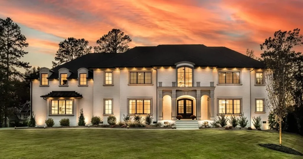 Luxury estate with custom lighting captured at sunset, professionally photographed in Raleigh by real estate photographer R. Huggins